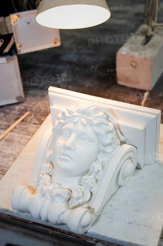 Female head in stucco on a workbench