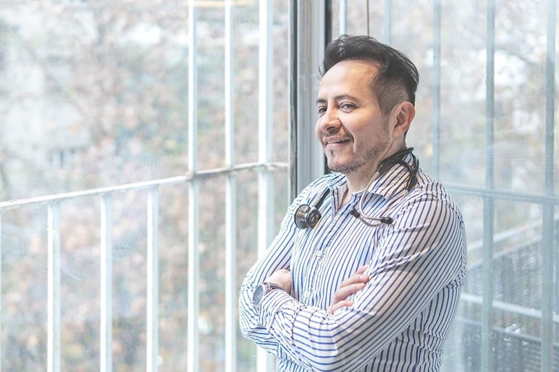 Portrait of latin doctor posing in his office