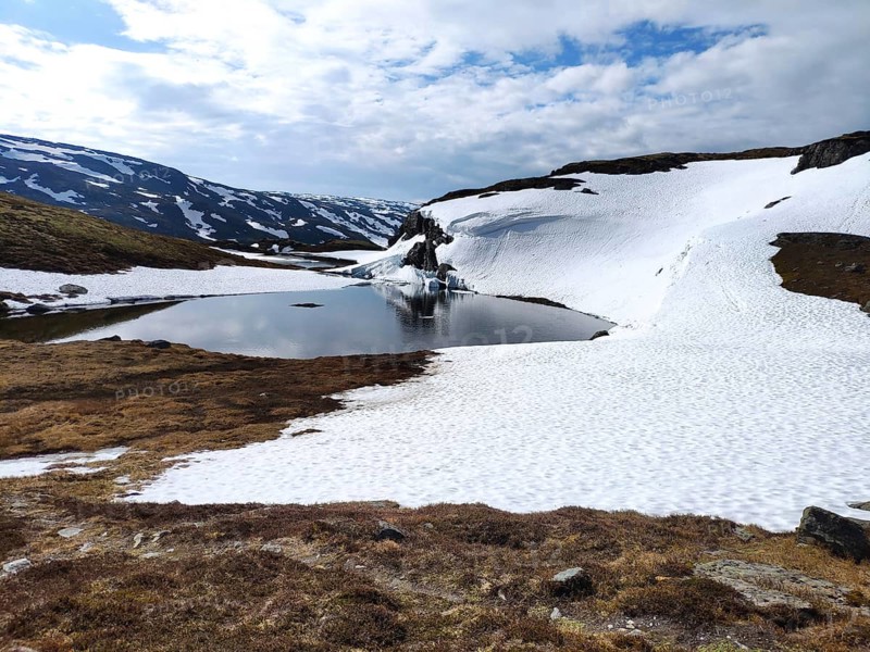 Lake surrounded by snow-capped mountain