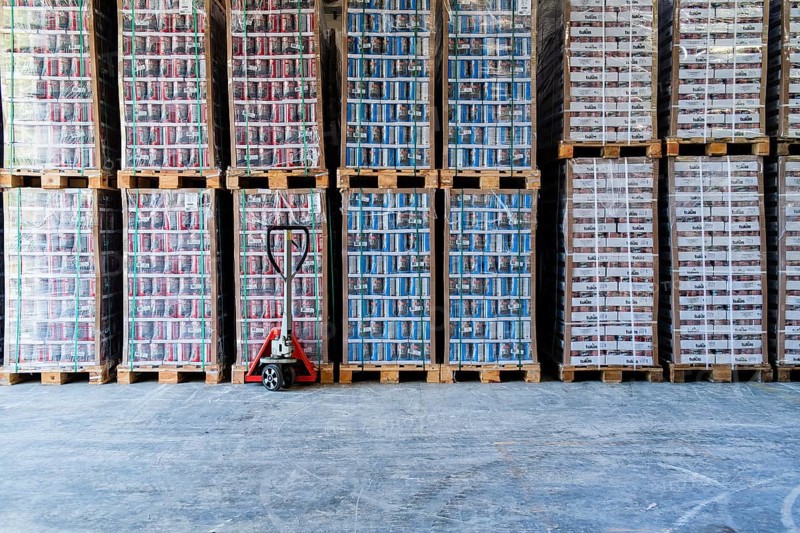 High-bay warehouse with canned goods stacked on pallets