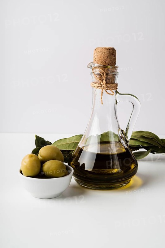 Close up bottle organic olive oil olives