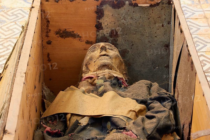 Coffin with mummy lying on the floor