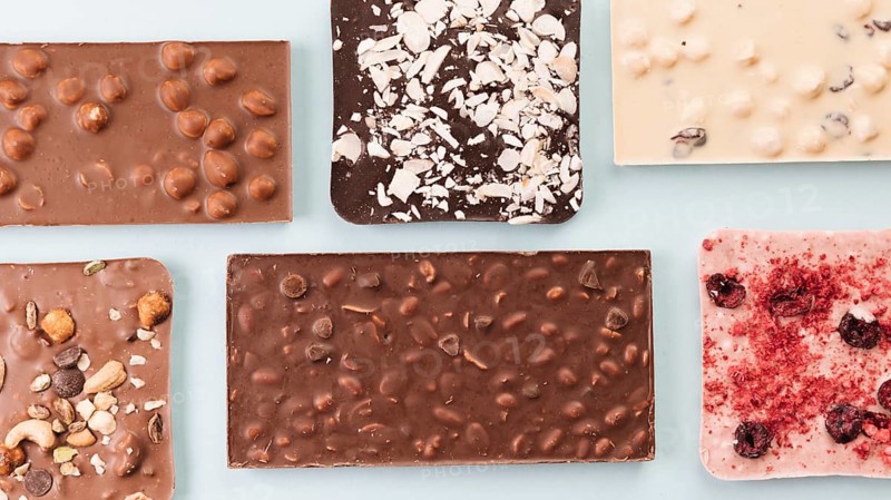 Top view chocolate bars with nuts berries