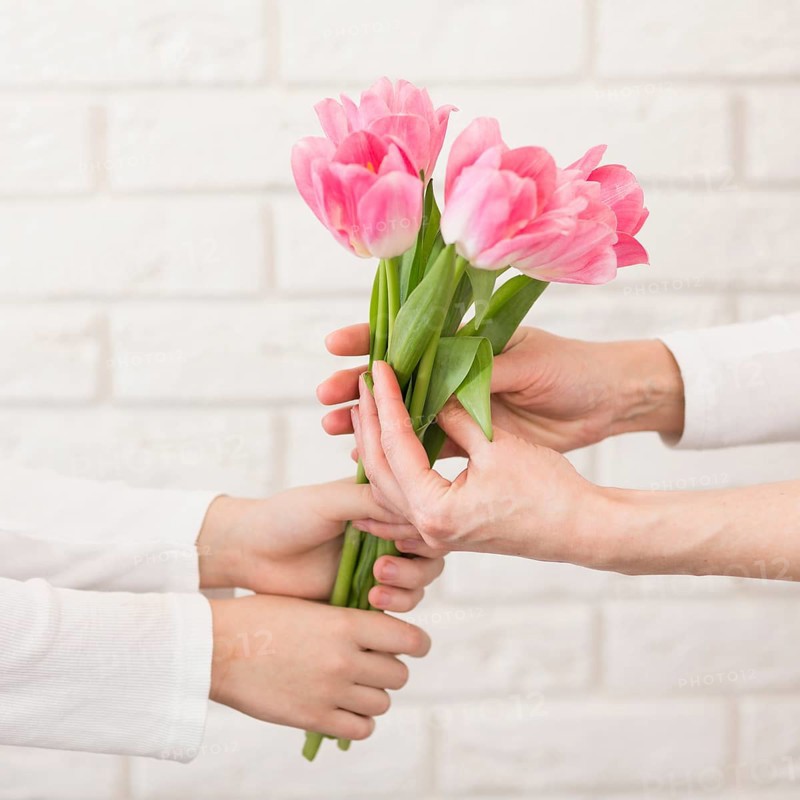Boy offering flowers mother