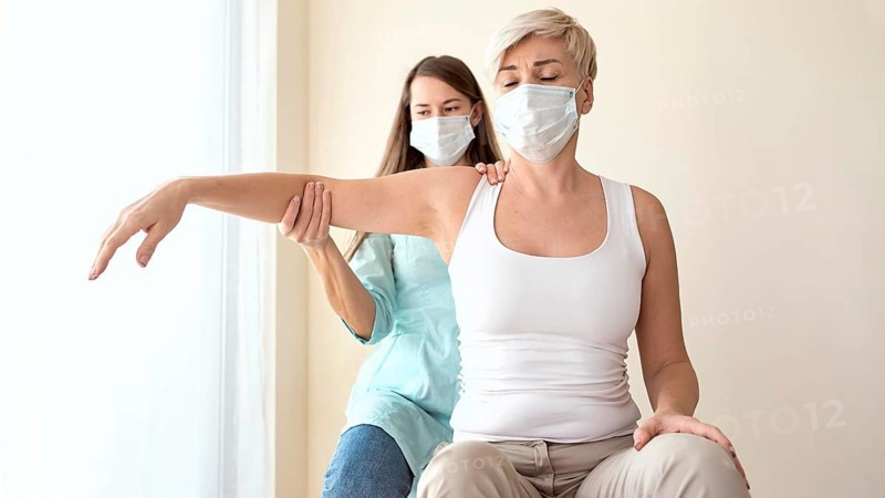 Female patient undergoing therapy physiotherapist