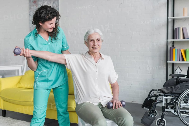 Physiotherapist working elderly patient modern clinic