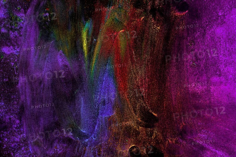 Multicolored holi colors smudged with hand black background