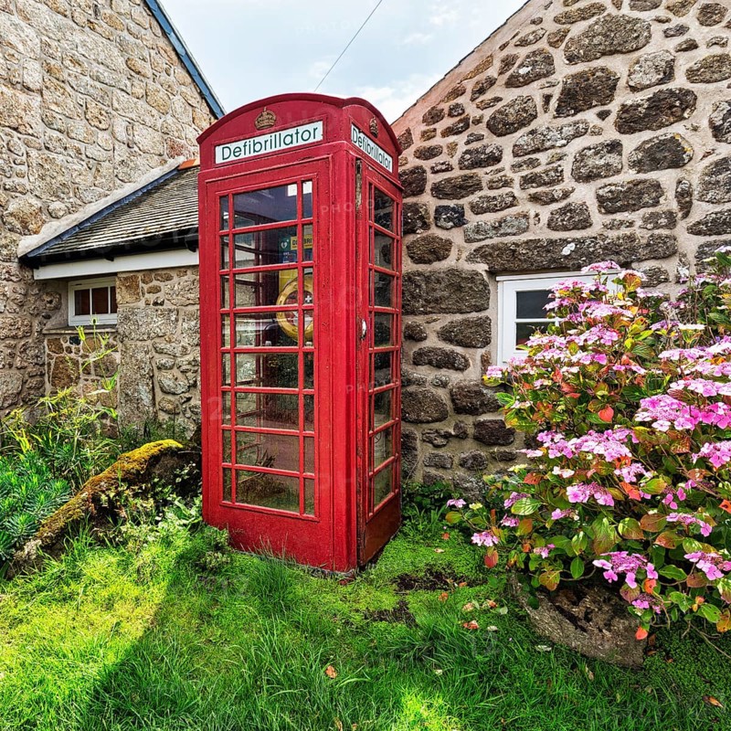 Red telephone box with defibrillator inscription