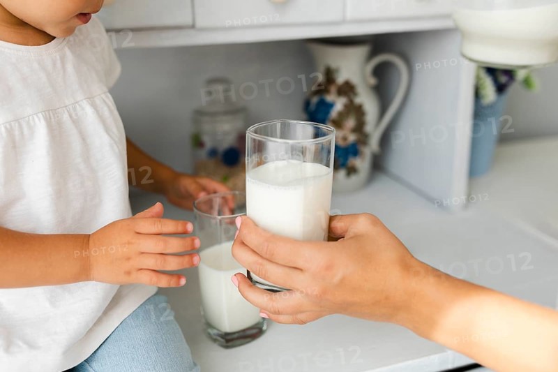Mother hand offering glass milk