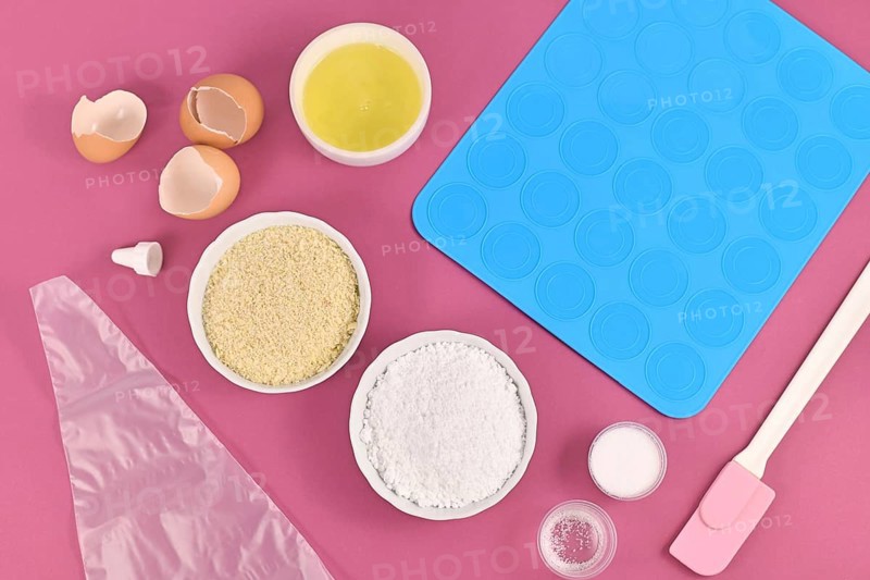 Ingredients for making homemade French Macaron sweets including powdered sugar