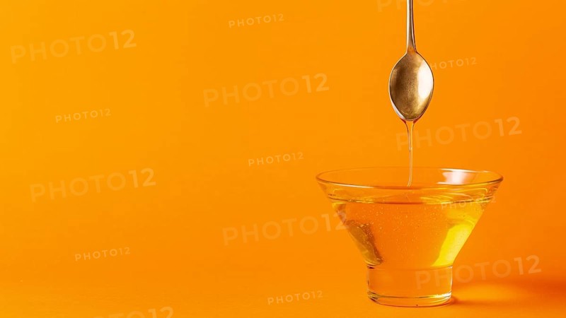 Honey dripping off spoon bowl