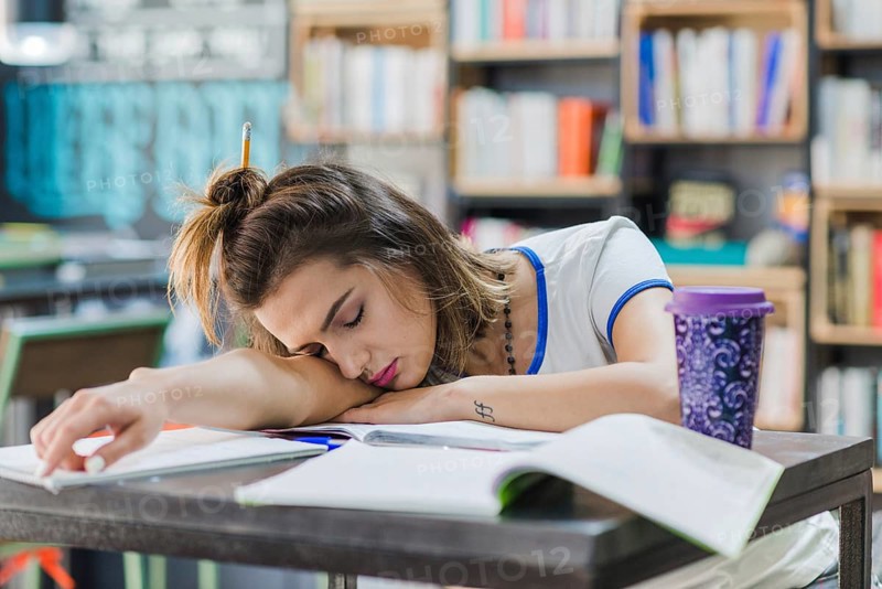 Girl with hairbun sleeping table