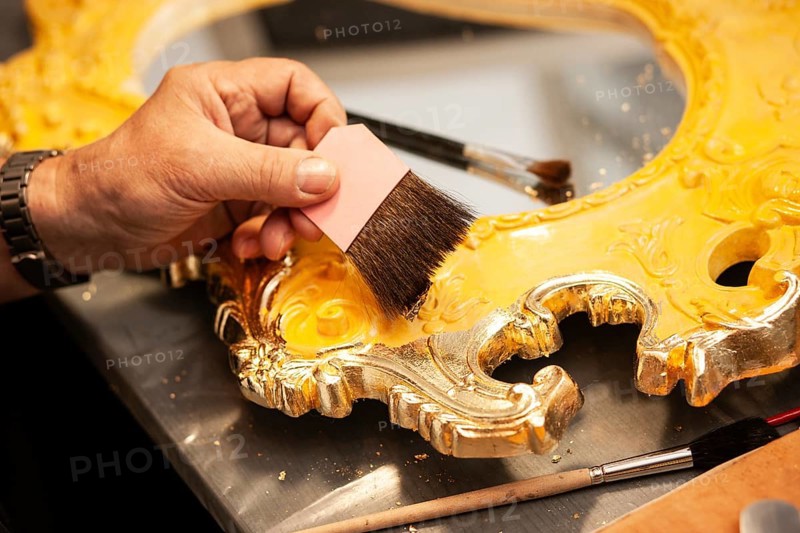 Detail of a mirror gilded with gold leaf