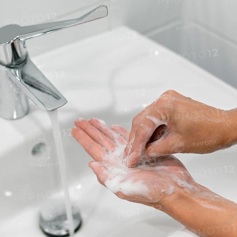 Person washing hands with soap