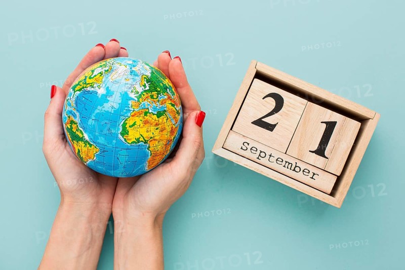 Top view hands holding earth globe calendar