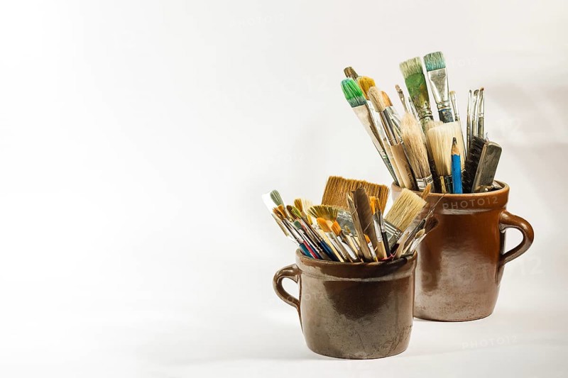 Artistic brushes and painting tools in old clay