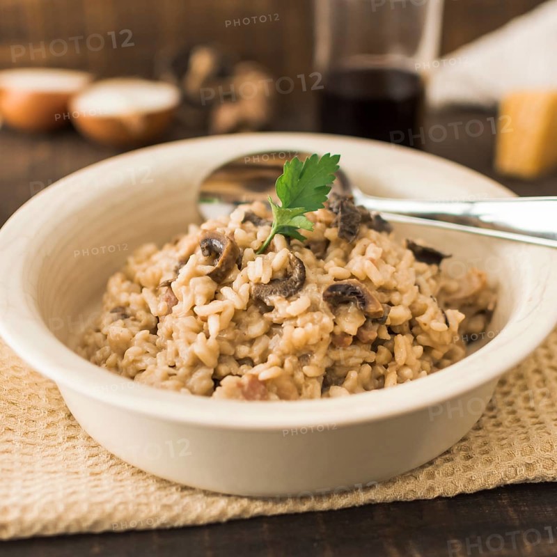 Delicious mushroom risotto white bowl with spoon