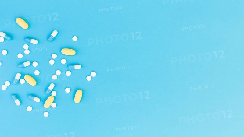 Top view medical pills capsules blue background
