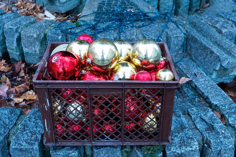 Red and golden Christmas tree balls in a plastic basket