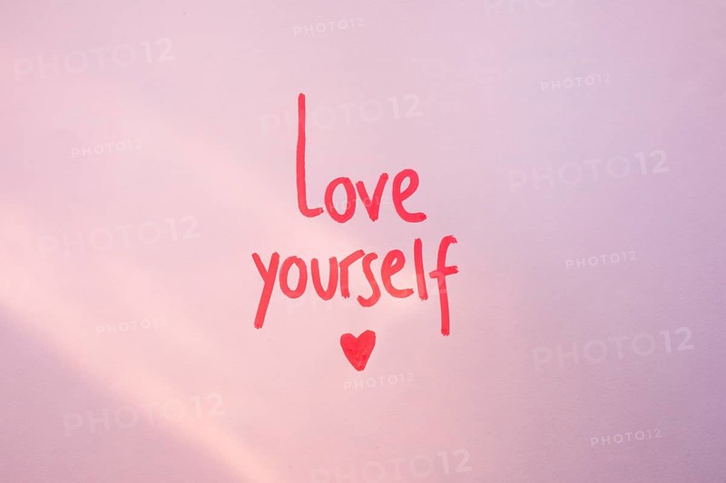 Love yourself inscription purple table