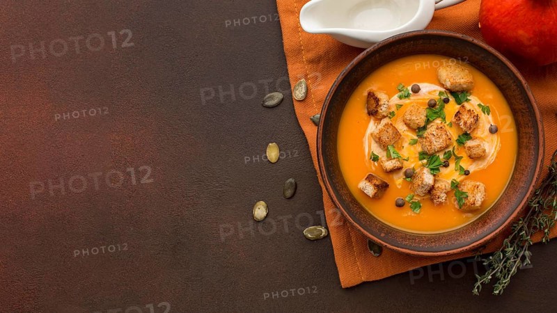 Flat lay winter squash soup bowl with copy space