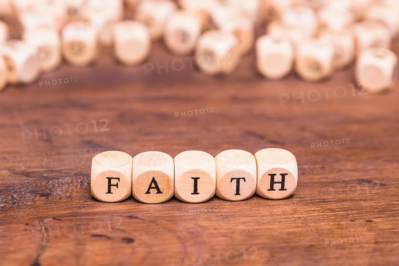 Wooden cubes with word faith table