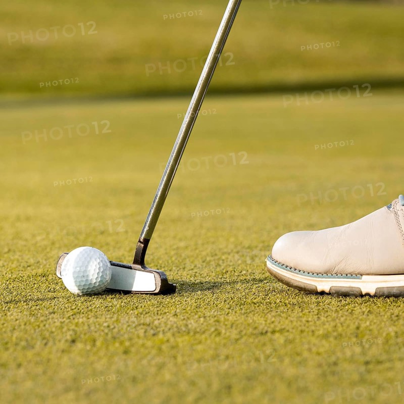 Man using club hit golf ball