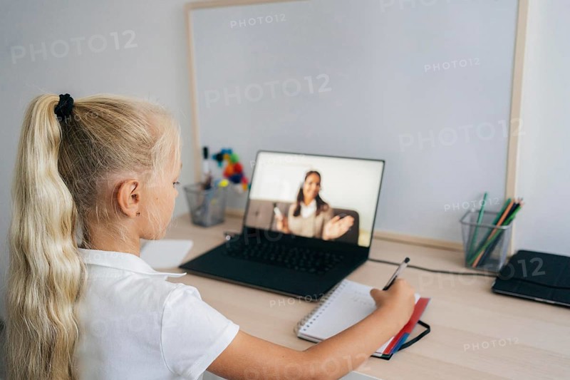 Young girl paying attention online class