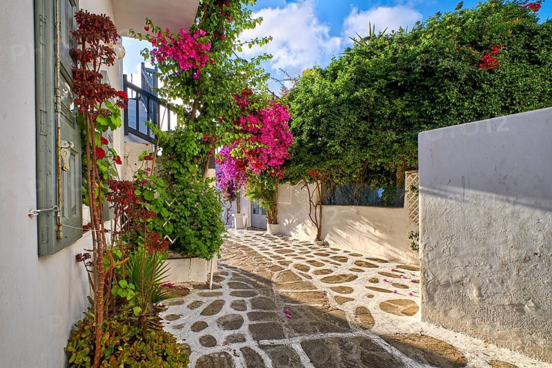Romantic traditional narrow streets and beautiful walkways of Greek island towns. Whitewashed houses