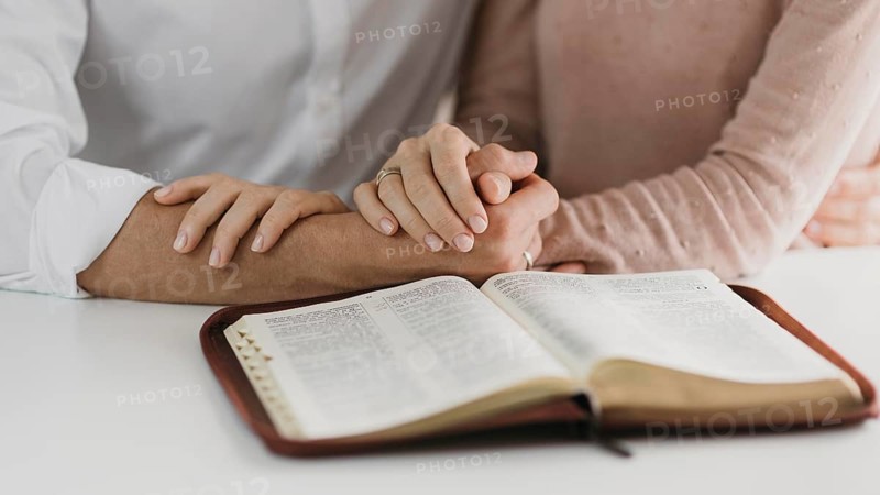 Husband wife reading bible together