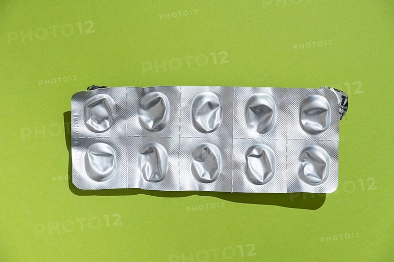 Empty tablet blister pack against a monochrome background