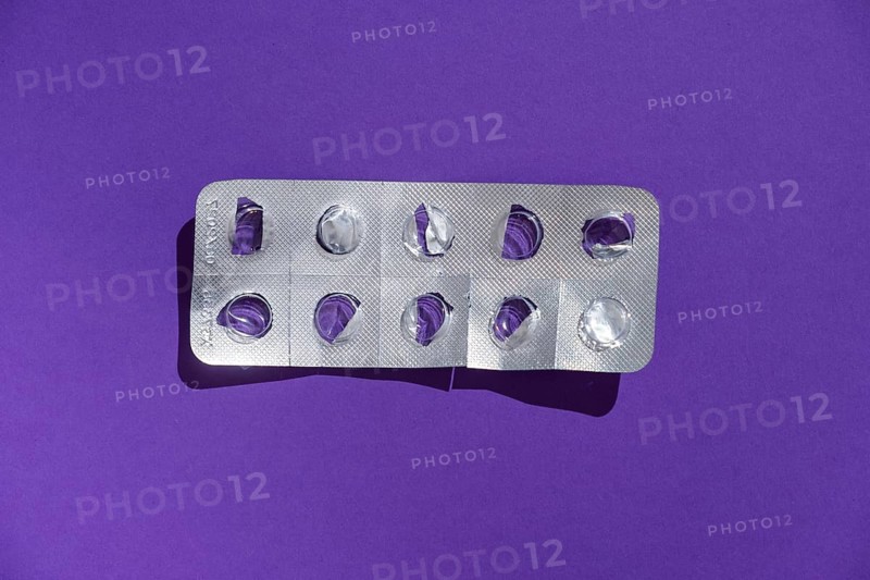Empty tablet blister pack against a monochrome background