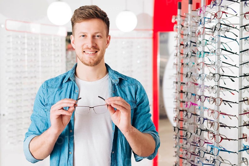 Man looking new glasses optometrist