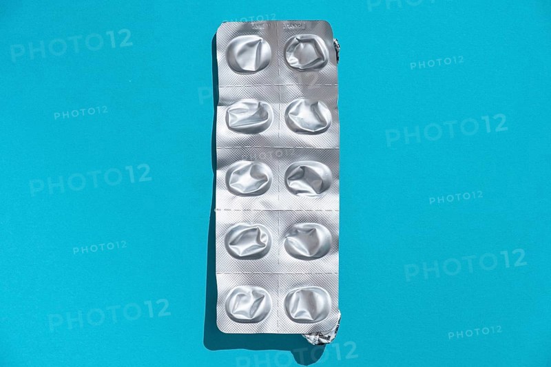 Empty tablet blister pack against a monochrome background