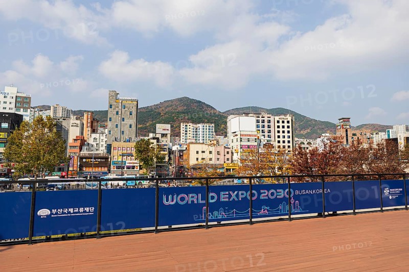 Station forecourt with high-rise buildings and shops