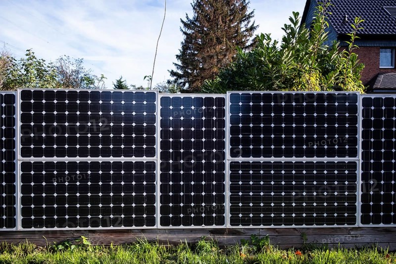 Solar panels as a garden fence and privacy screen of a house on a street in Langenfeld