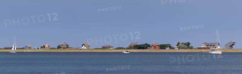 Sailing boats and beach houses along the Baltic Sea on the peninsula Graswarder
