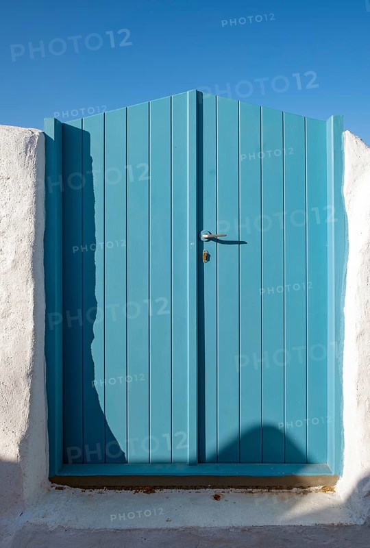 Blue wooden door with clear sky in the backgroud. Ia
