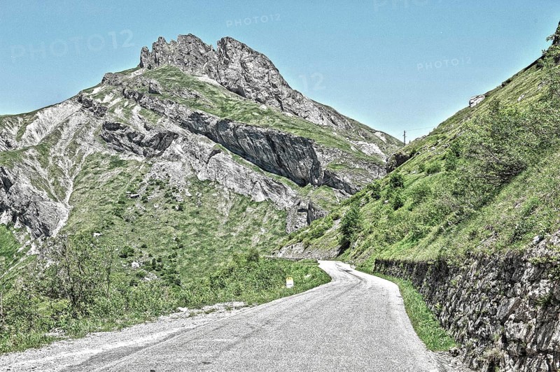Photo with reduced dynamic range saturation HDR of mountain pass alpine mountain road alpine road pass road pass Cormet de Roselend