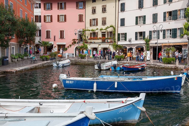 Houses and fishing boats in the old harbour of Limone sul Garda