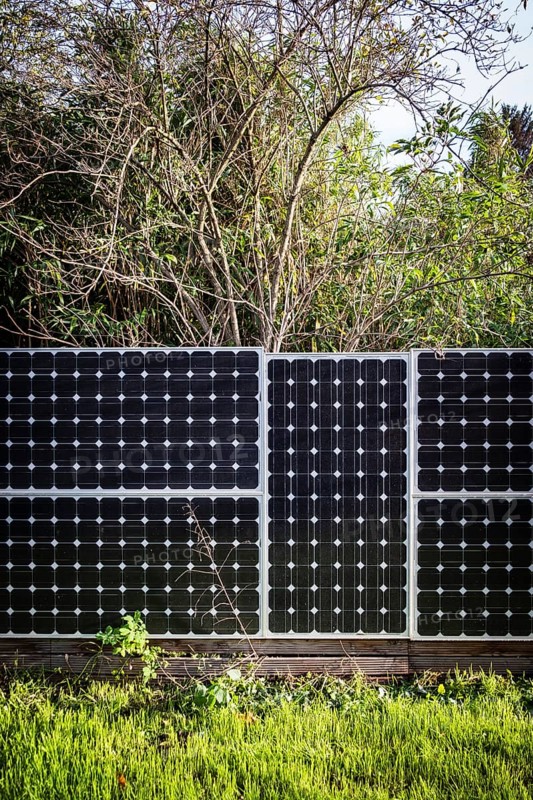 Solar panels as a garden fence and privacy screen of a house on a street in Langenfeld