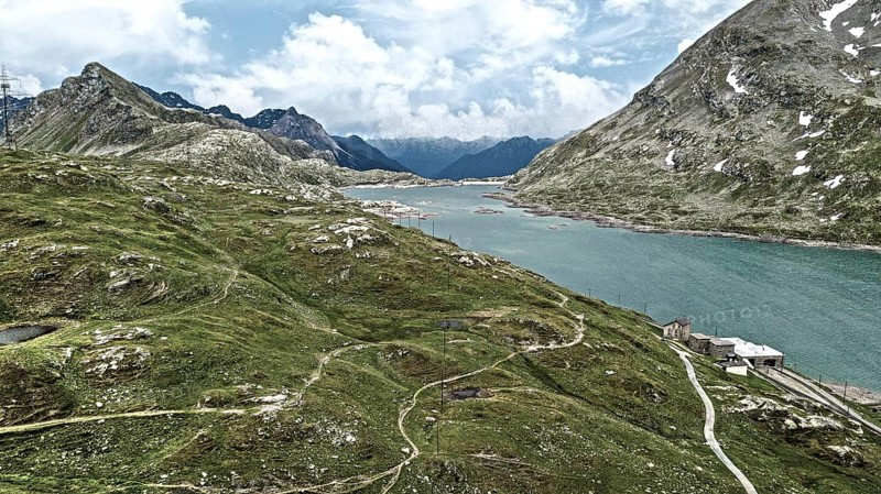 Photo with reduced dynamics saturation HDR of mountain lake at mountain pass alpine mountain road alpine road pass road Bernina Pass Bernina Pass