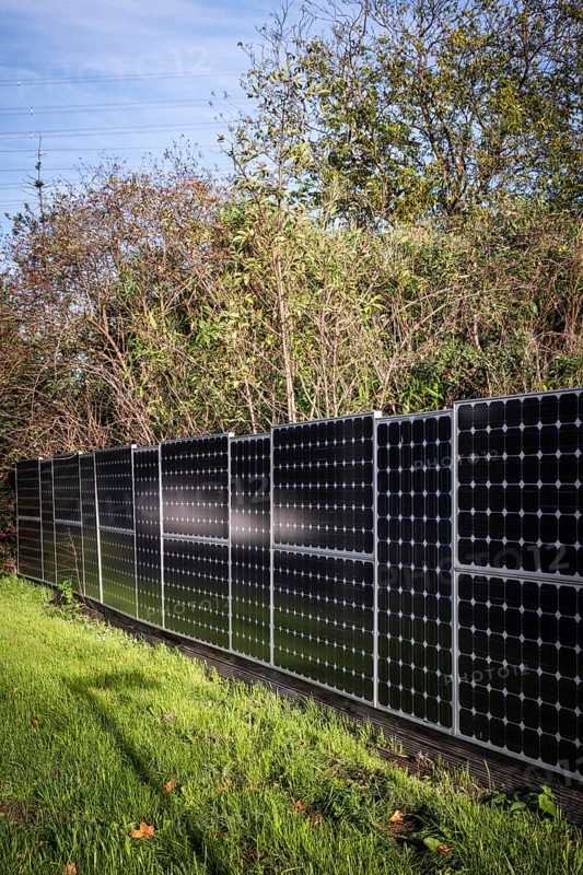 Solar panels as a garden fence and privacy screen of a house on a street in Langenfeld