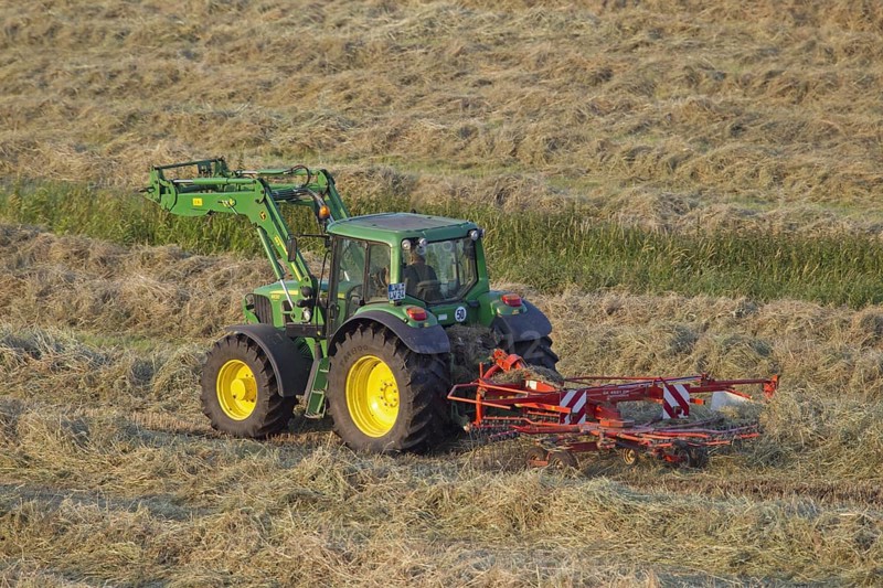 Tractor with rotary hay rake