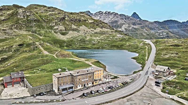 Photo with reduced dynamics saturation HDR of mountain lake at mountain pass alpine mountain road alpine road pass road Bernina Pass Bernina Pass