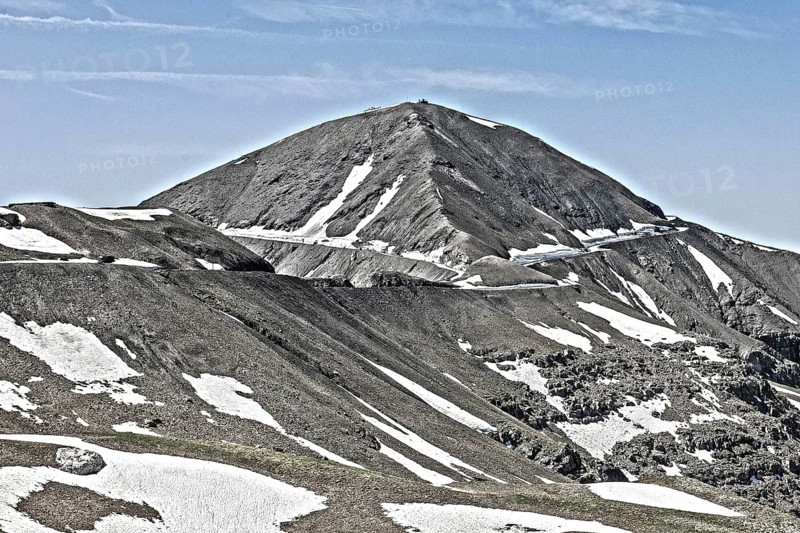 Photo with reduced dynamic saturation HDR of mountain pass alpine mountain road alpine road pass road pass view of highest asphalted alpine road ring road around Cime de la Bonette Col de la Bonette in high mountains above tree line