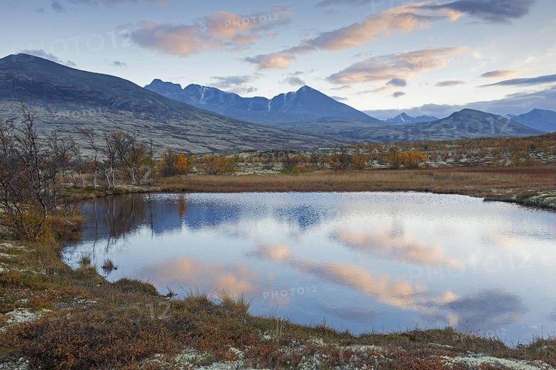 Tundra landscape with lake in autumn