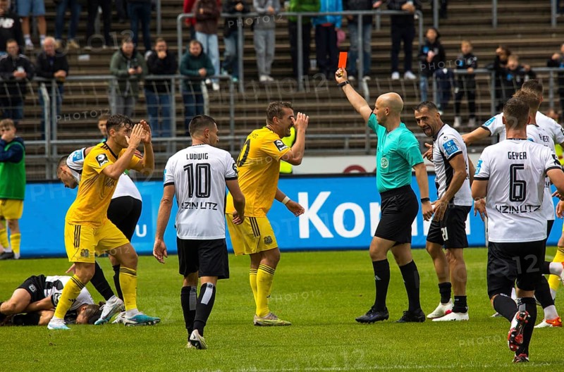 Referee Nicolas Winter shows the red card to player Luca KERBER left