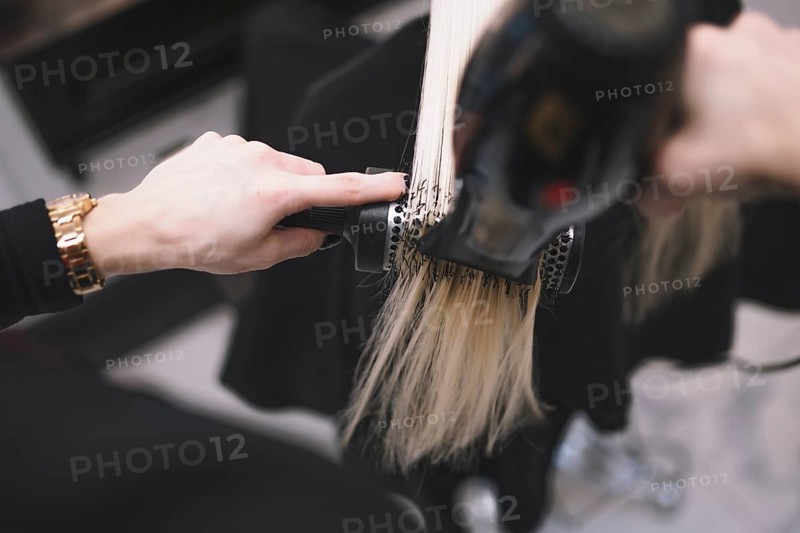 Crop stylist setting hair with brush