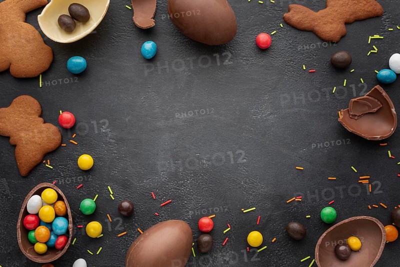 Top view chocolate easter eggs with candy cookies frame